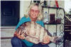 THis is my ma with the fish that i caught. That was probably the happiest day of my life.  I ate the insides of that fish, and then tarred the outside skins and hung it on my wall!